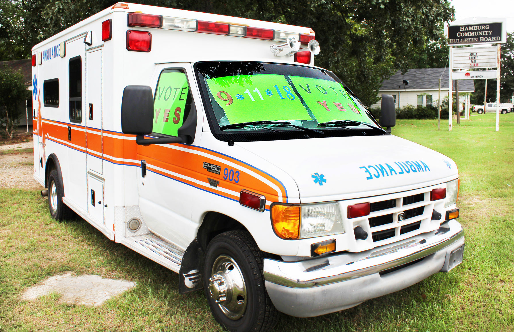 Ambulance with signs implores voters to ratify tax